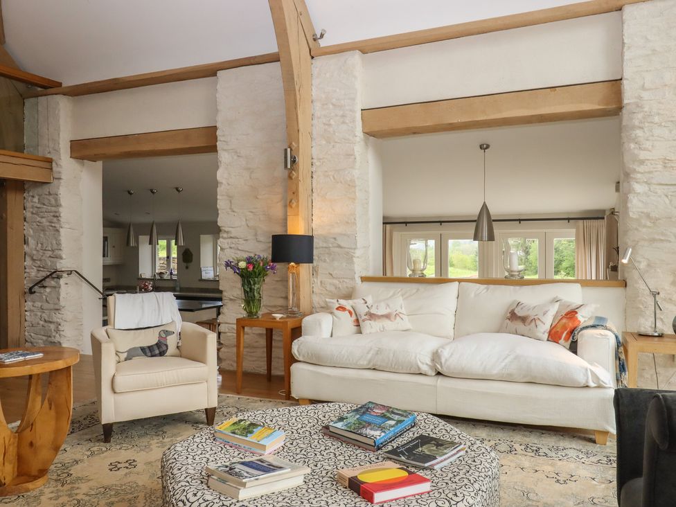 A living room with sofa and coffee table at Lower Velwell Barn in Totnes