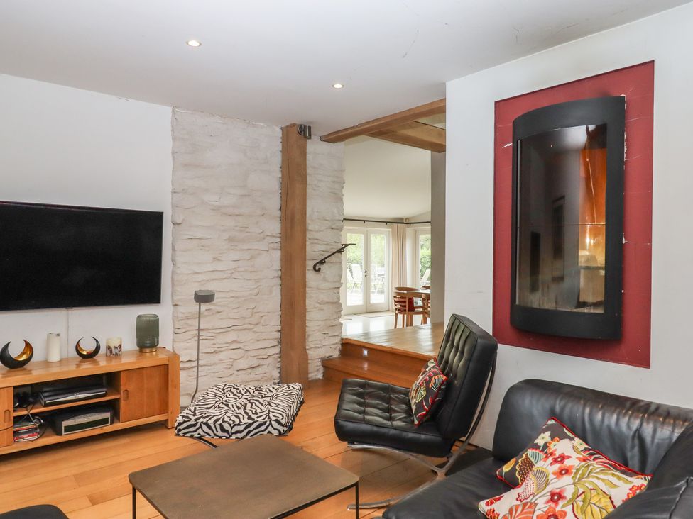 A living room with a television and a sofa at Lower Velwell Barn in Totnes