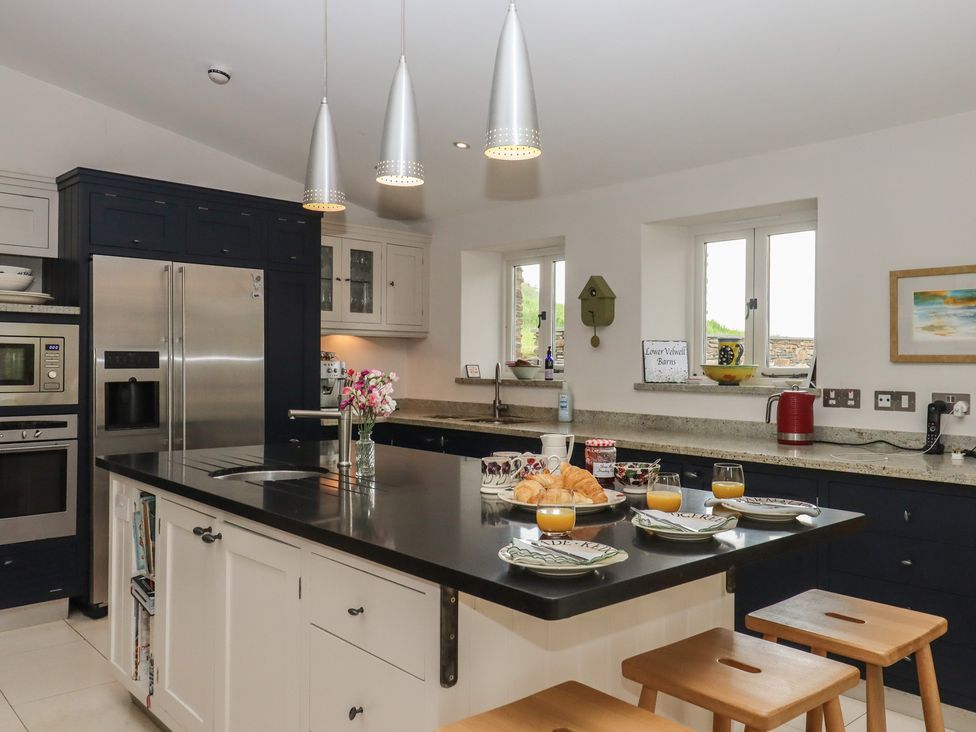 A kitchen with appliances and tableware at Lower Velwell Barn in Totnes