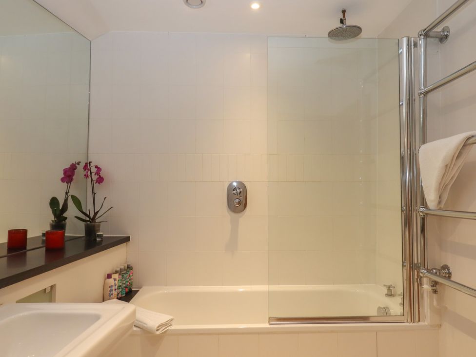 A bathroom with a bathtub and shower at Lower Velwell Barn in Totnes