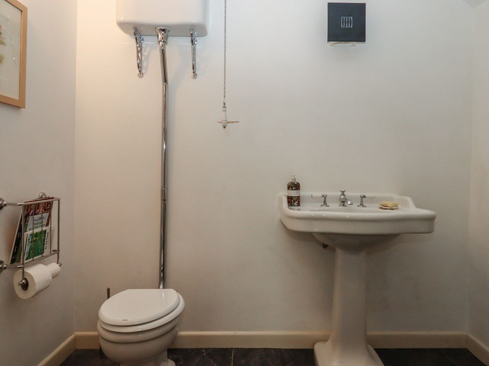 A bathroom with a toilet and sink at Lower Velwell Barn in Totnes