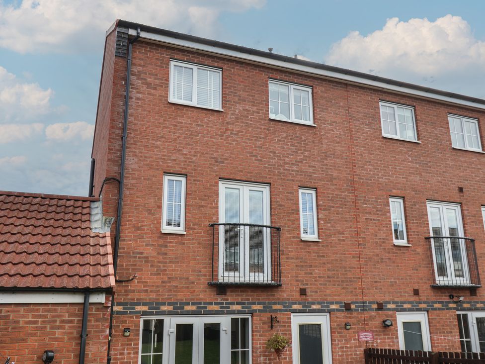 A building exterior with multiple windows and a balcony at 33 Murrayfield Gardens Whitby