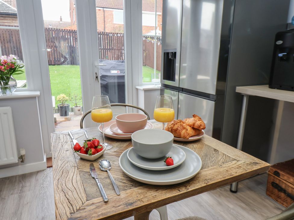 A kitchen with a table set for breakfast at Pearl Stone House in Whitby