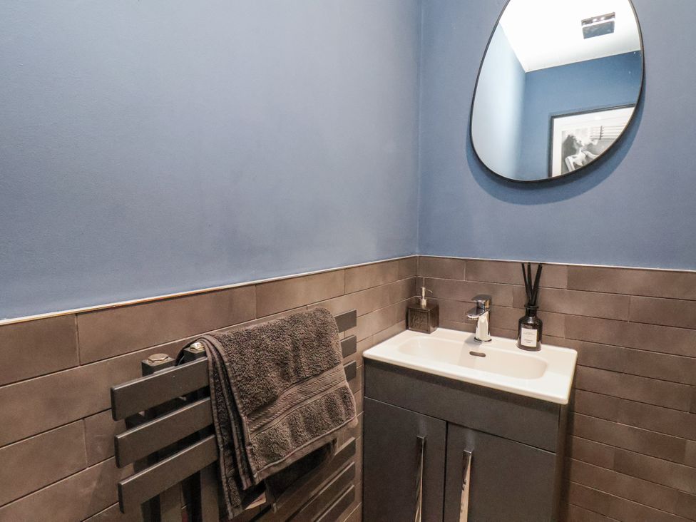A bathroom with a sink and towel rack at Pearl Stone House in Whitby