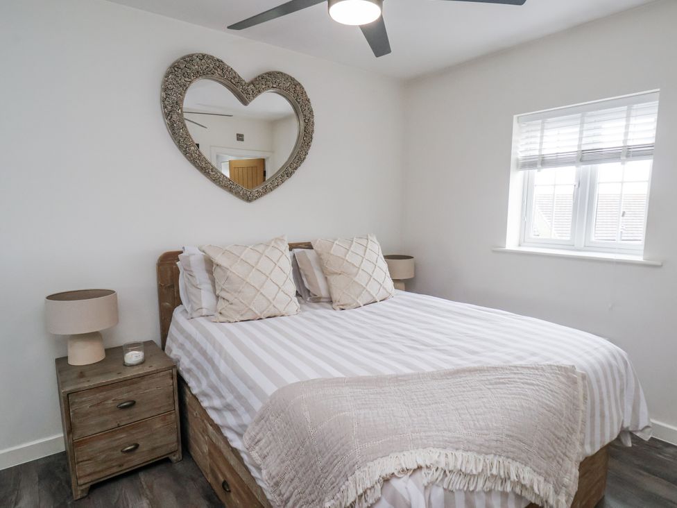 A bedroom with a bed and nightstand at Pearl Stone House in Whitby