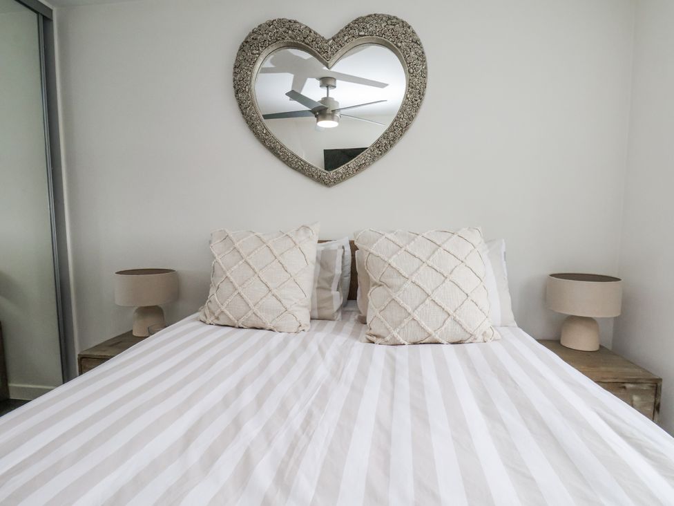 A bedroom with a bed and pillows at Pearl Stone House in Whitby