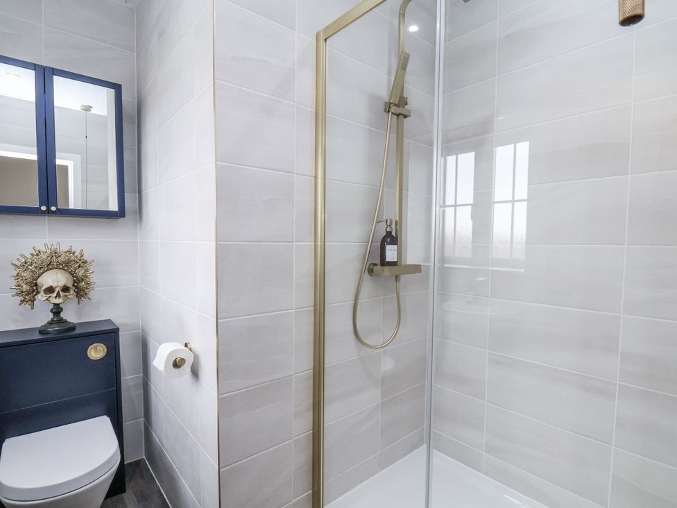 A bathroom with a shower and a toilet at Pearl Stone House in Whitby