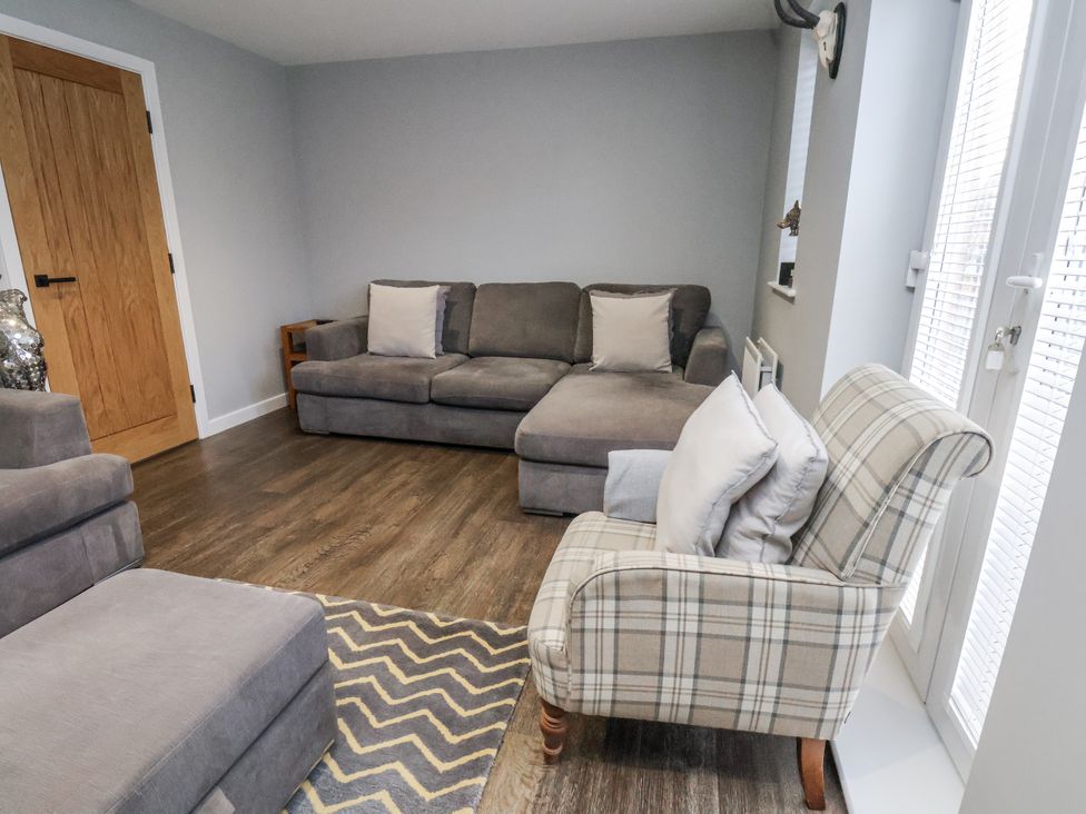 A snug room with a sofa and armchair at Pearl Stone House in Whitby