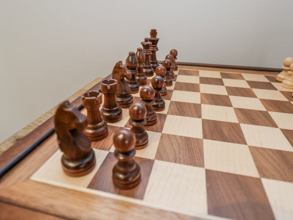 A chessboard with wooden chess pieces at Pearl Stone House in Whitby