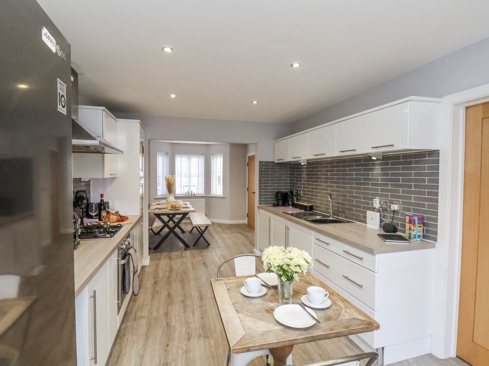 A kitchen with a table and chairs at Pearl Stone House in Whitby