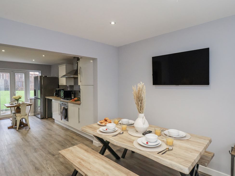 A kitchen with a table and chairs at Pearl Stone House in Whitby