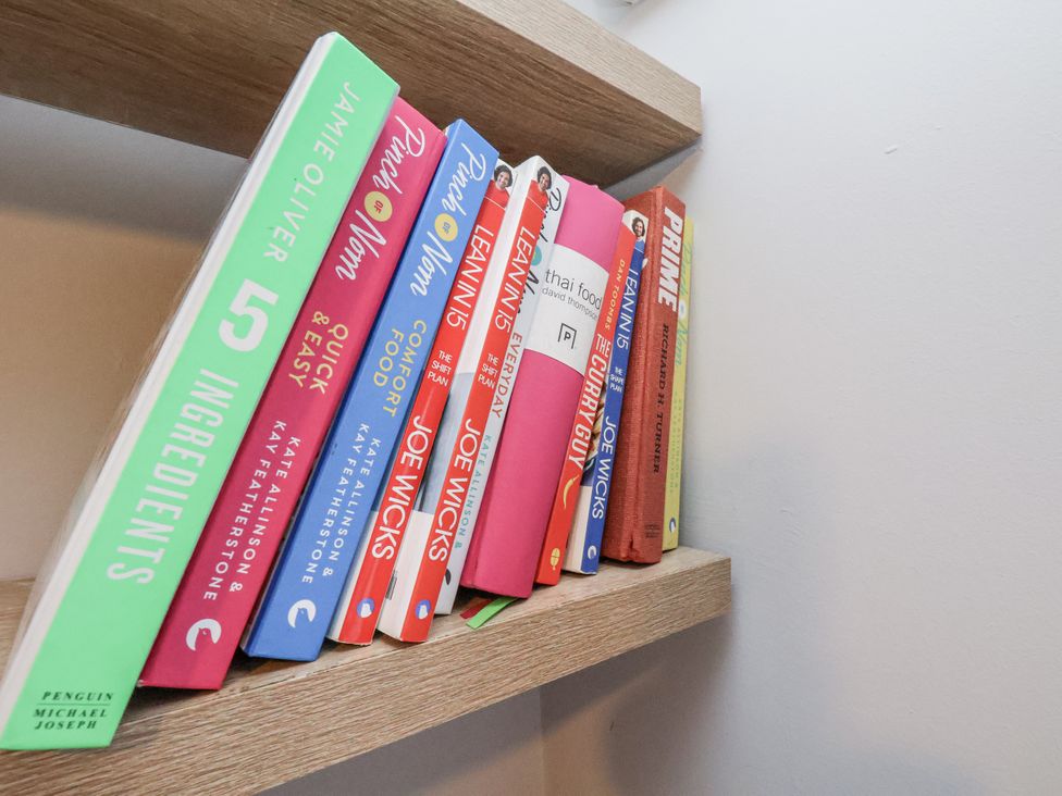 A bookshelf with various cooking books at Pearl Stone House in Whitby