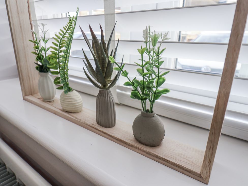 A decorative plant arrangement on a shelf at Pearl Stone House in Whitby