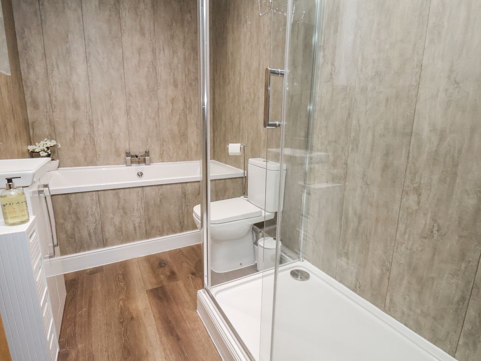 A bathroom with a bath tub and shower at Pearl Stone House in Whitby