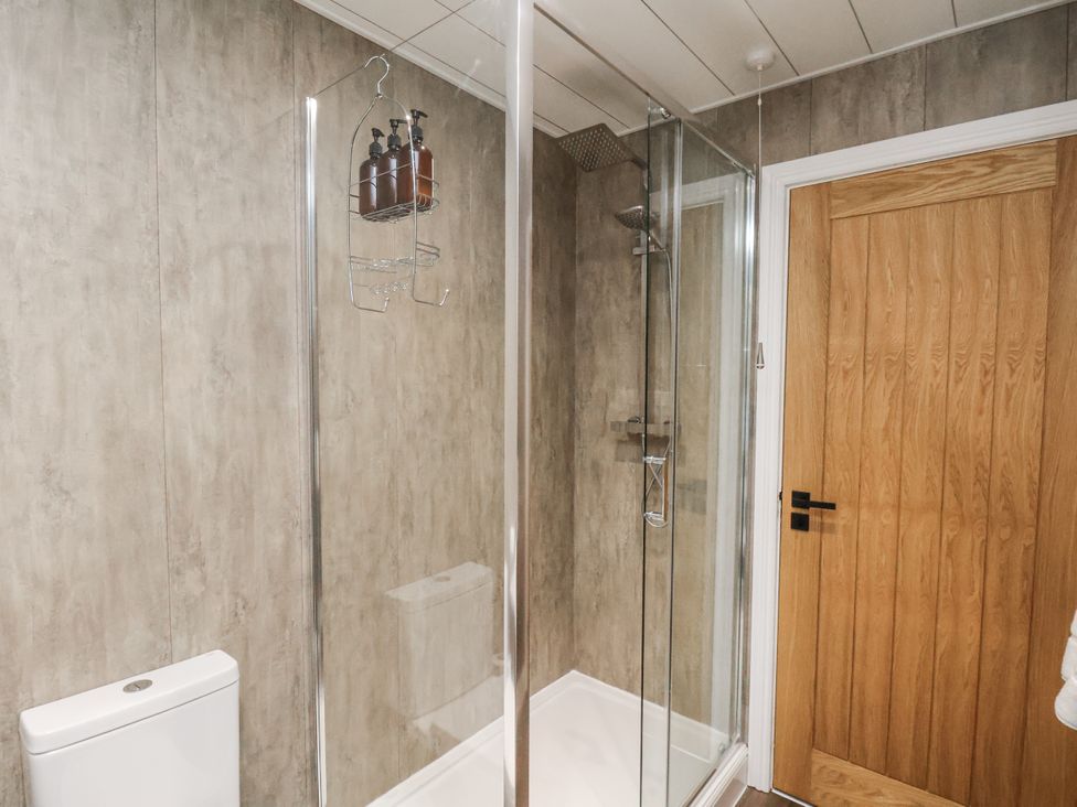 A bathroom with a shower and toilet at Pearl Stone House in Whitby
