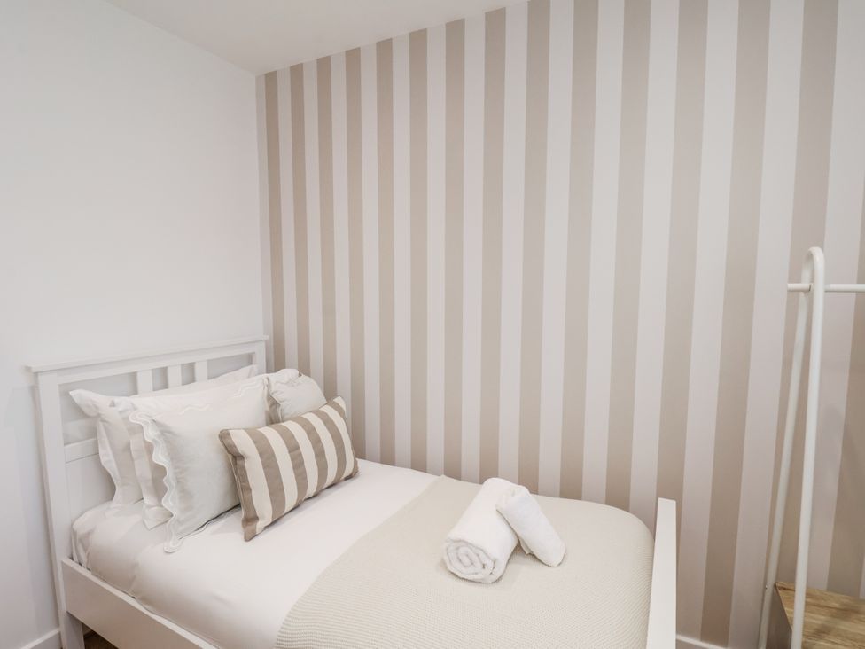 A bedroom with a bed and pillows at Pearl Stone House in Whitby