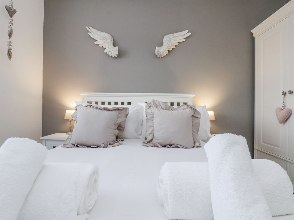 A bedroom with a bed and pillows at Pearl Stone House in Whitby