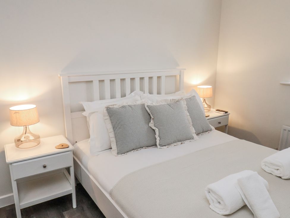 A bedroom with a bed and bedside tables at Pearl Stone House Whitby