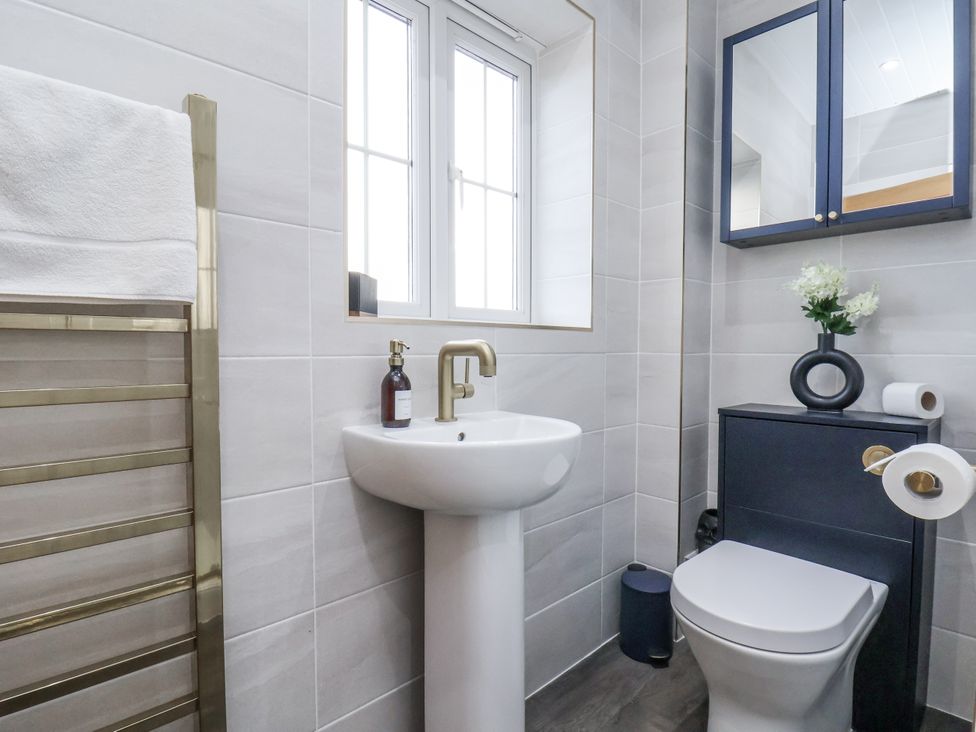 A bathroom with a sink and toilet at Pearl Stone House in Whitby