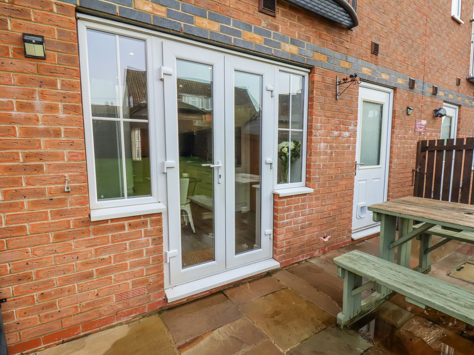 A patio with double doors and a table at Pearl Stone House in Whitby