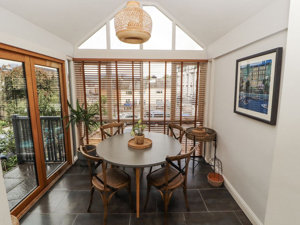 A dining room with a round table and chairs at 43 Station Road Keswick