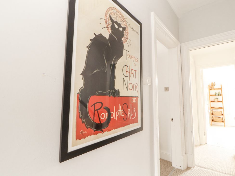 A poster of a cat in a hallway at 43 Station Road Keswick