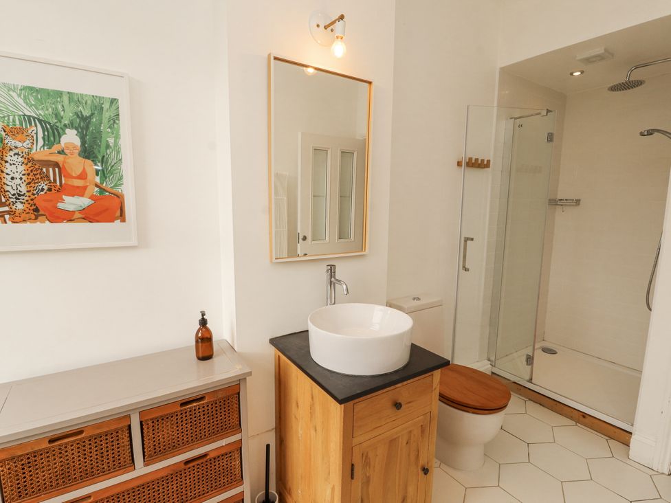 A bathroom with a sink, shower, and toilet at 43 Station Road in Keswick