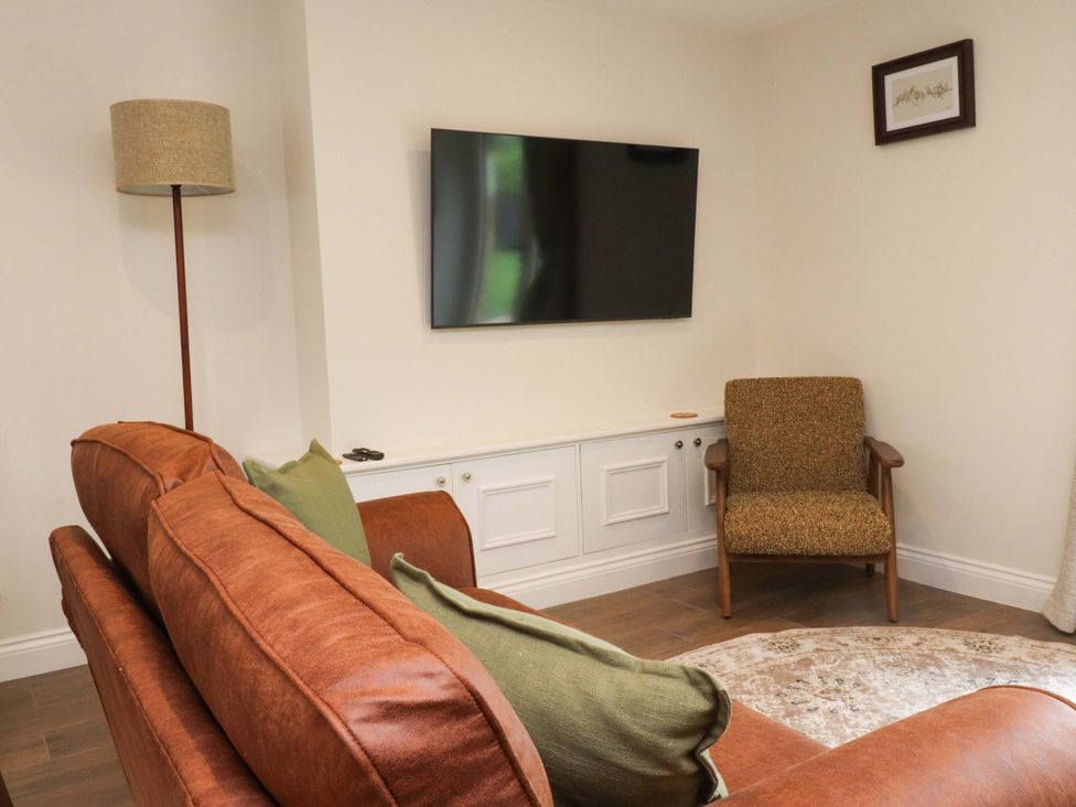 A living room with a sofa and armchair at Heron View