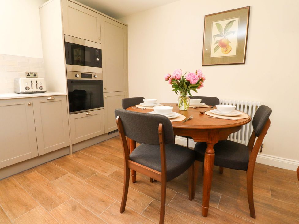A dining room with a round table set with dishes at Heron View