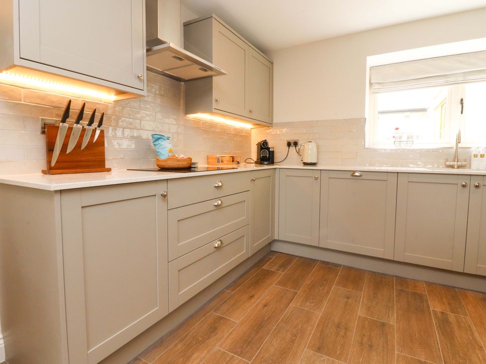 A kitchen with cabinets, counter, and appliances at Heron View