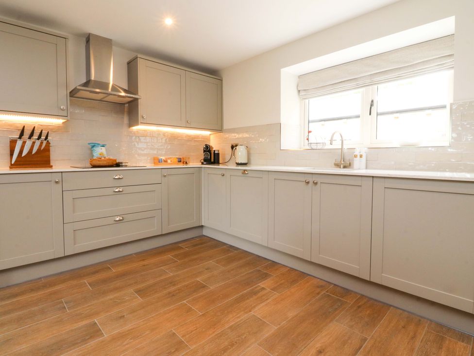 A kitchen with cabinets and appliances at Heron View