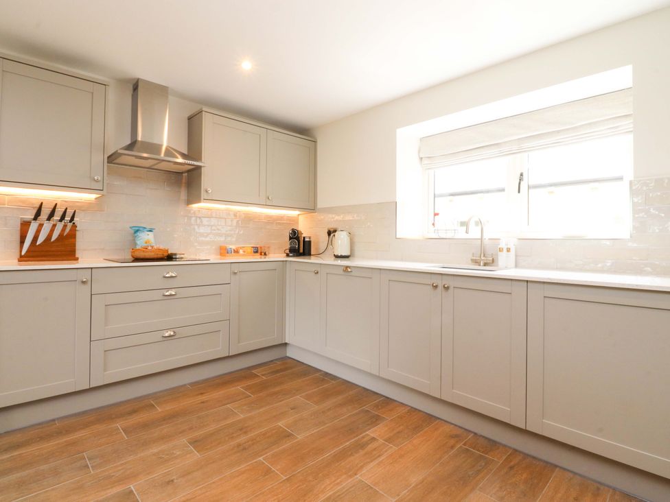A kitchen with cabinets and a sink at Heron View