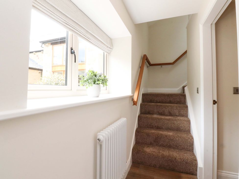 A staircase with a handrail in a hallway at Heron View