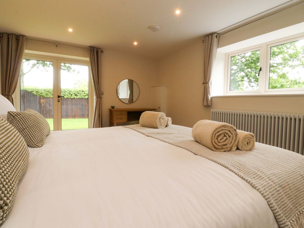 A bedroom with a bed and window at Heron View