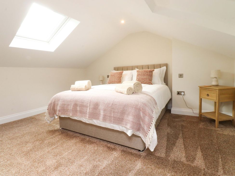 A bedroom with a bed and a bedside table at Heron View 