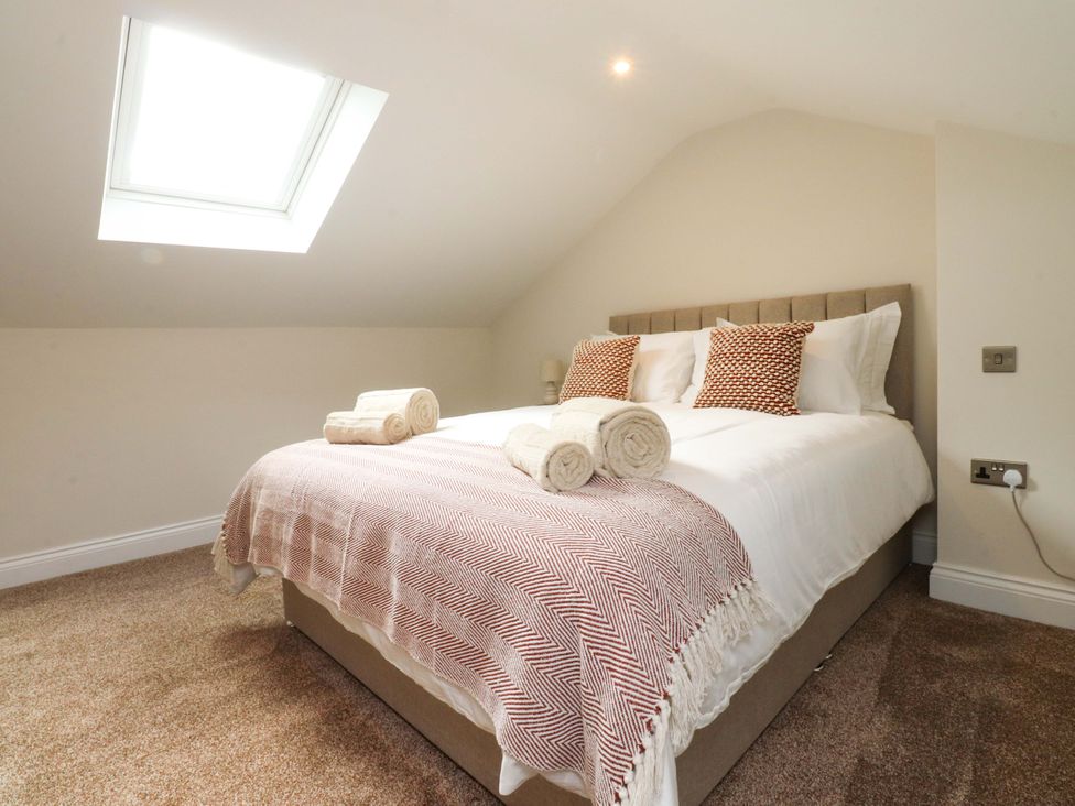 A bedroom with a bed and towels at Heron View