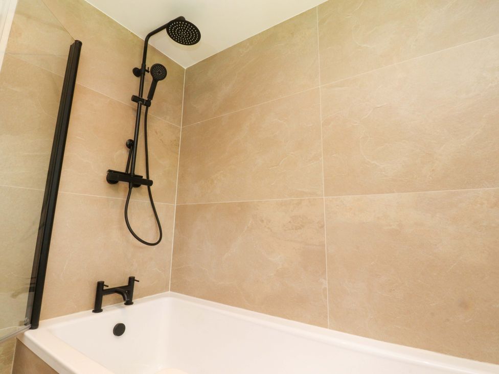 A bathtub with a shower system at Heron View