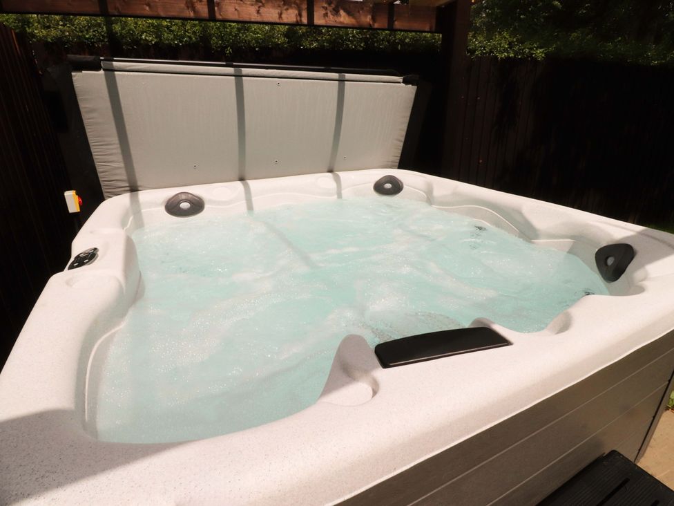 A hot tub with water and control panel at Heron View