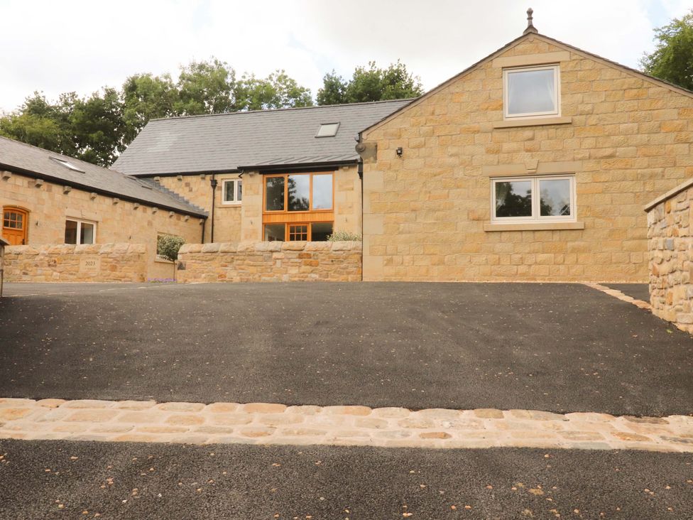 A stone house with a driveway at Heron View in 