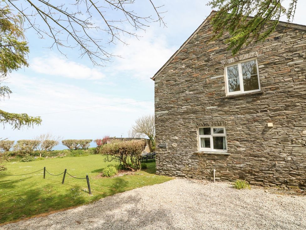 The exterior of a stone house with a garden at Tremorla in Boscastle