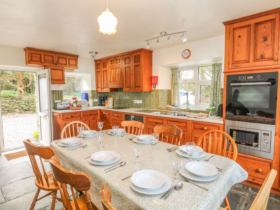 A kitchen with a dining table set for a meal at Tremorla in Boscastle