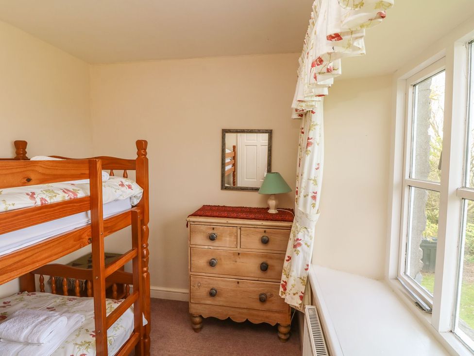 A bedroom with a bunk bed and a chest of drawers at Tremorla in Boscastle