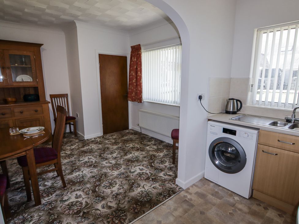 A dining room with a table and chairs at No.1 Vanderhoof Way Saundersfoot