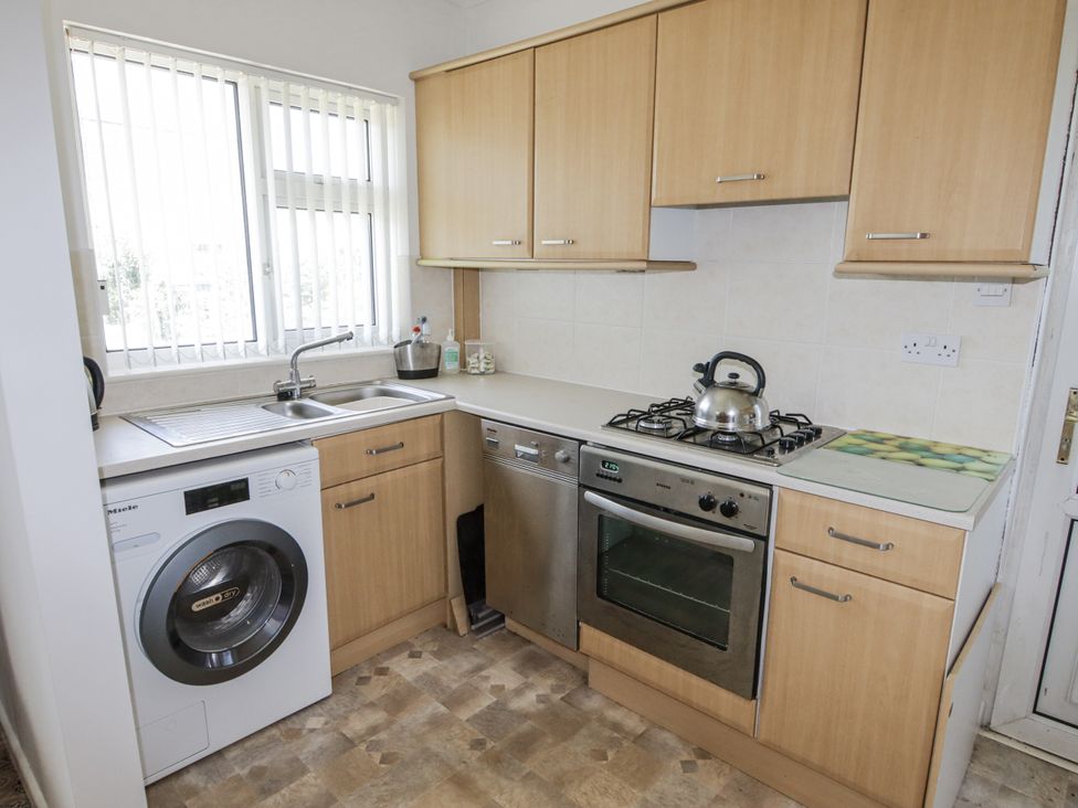 A kitchen with a sink and appliances at No.1 Vanderhoof Way Saundersfoot