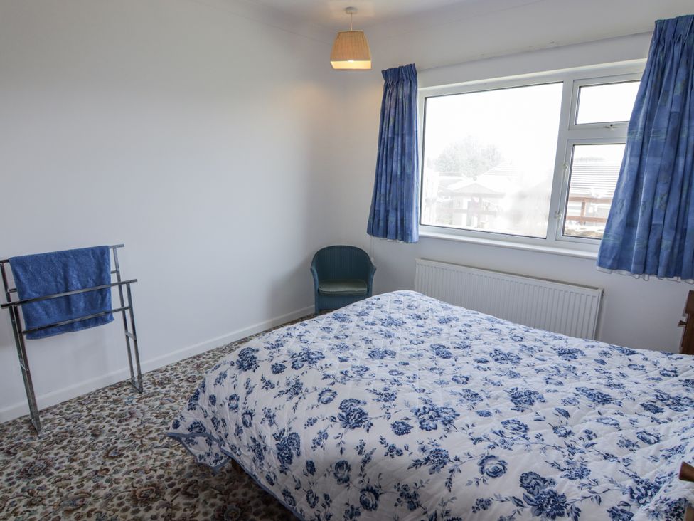 A bedroom with a bed and a window at No.1 Vanderhoof Way Saundersfoot