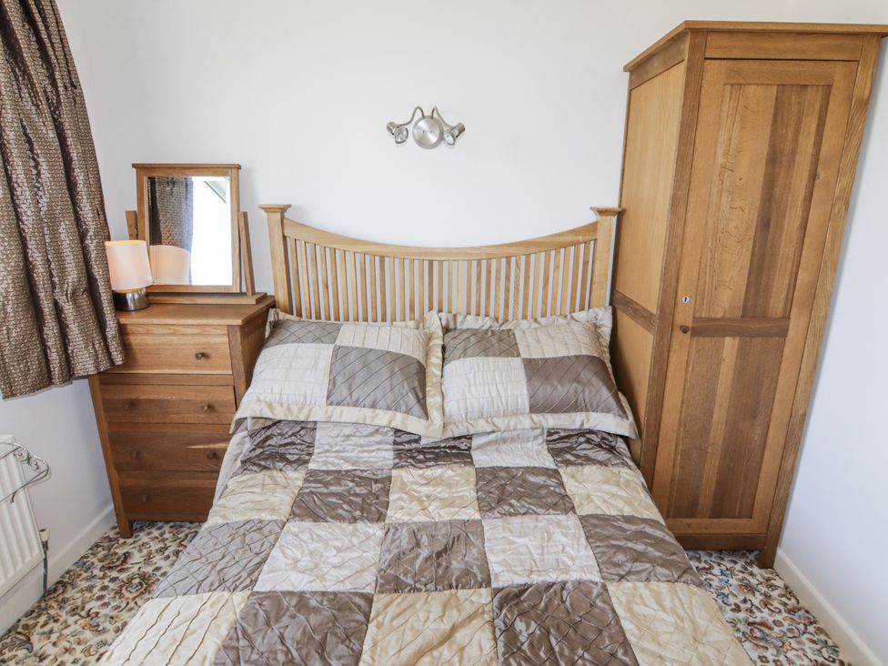 A bedroom with a bed and furniture at No.1 Vanderhoof Way Saundersfoot
