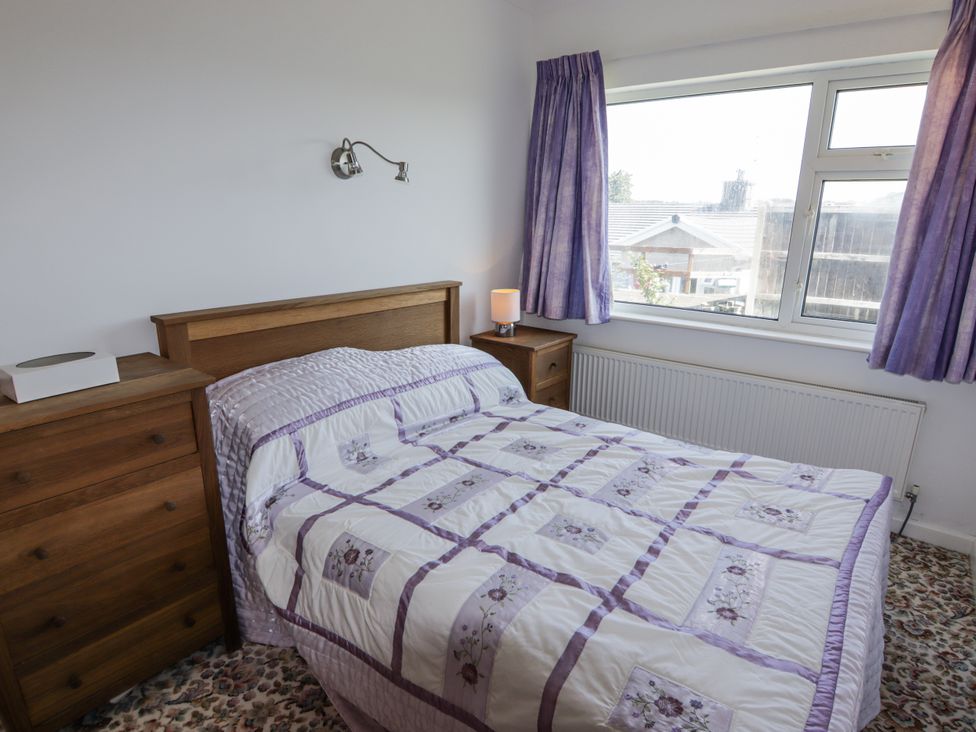 A bedroom with a bed and window at No.1 Vanderhoof Way Saundersfoot