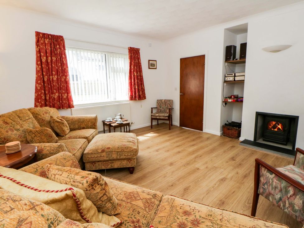 A living room with a sofa and fireplace at No.1 Vanderhoof Way in Saundersfoot