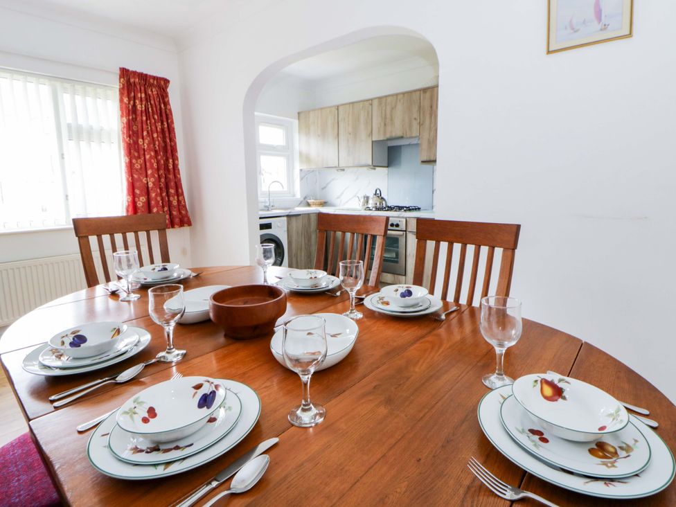 A dining room with a table set for dinner at No.1 Vanderhoof Way in Saundersfoot