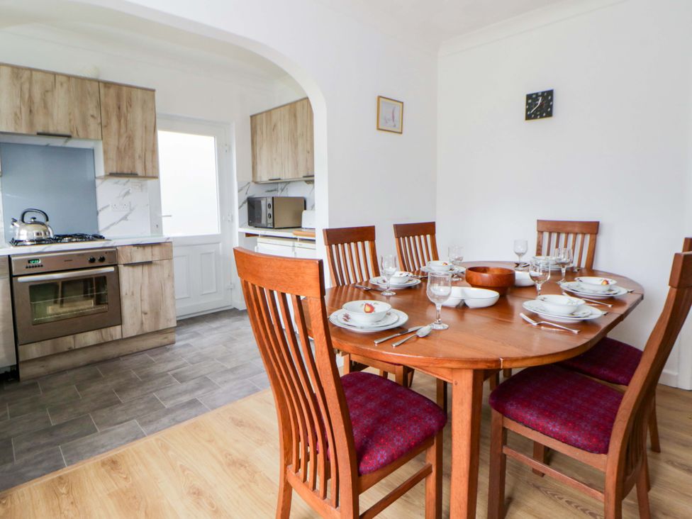 A dining room with a table and chairs at No.1 Vanderhoof Way, Saundersfoot